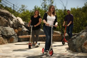 Intero Digital employees riding scooters outside