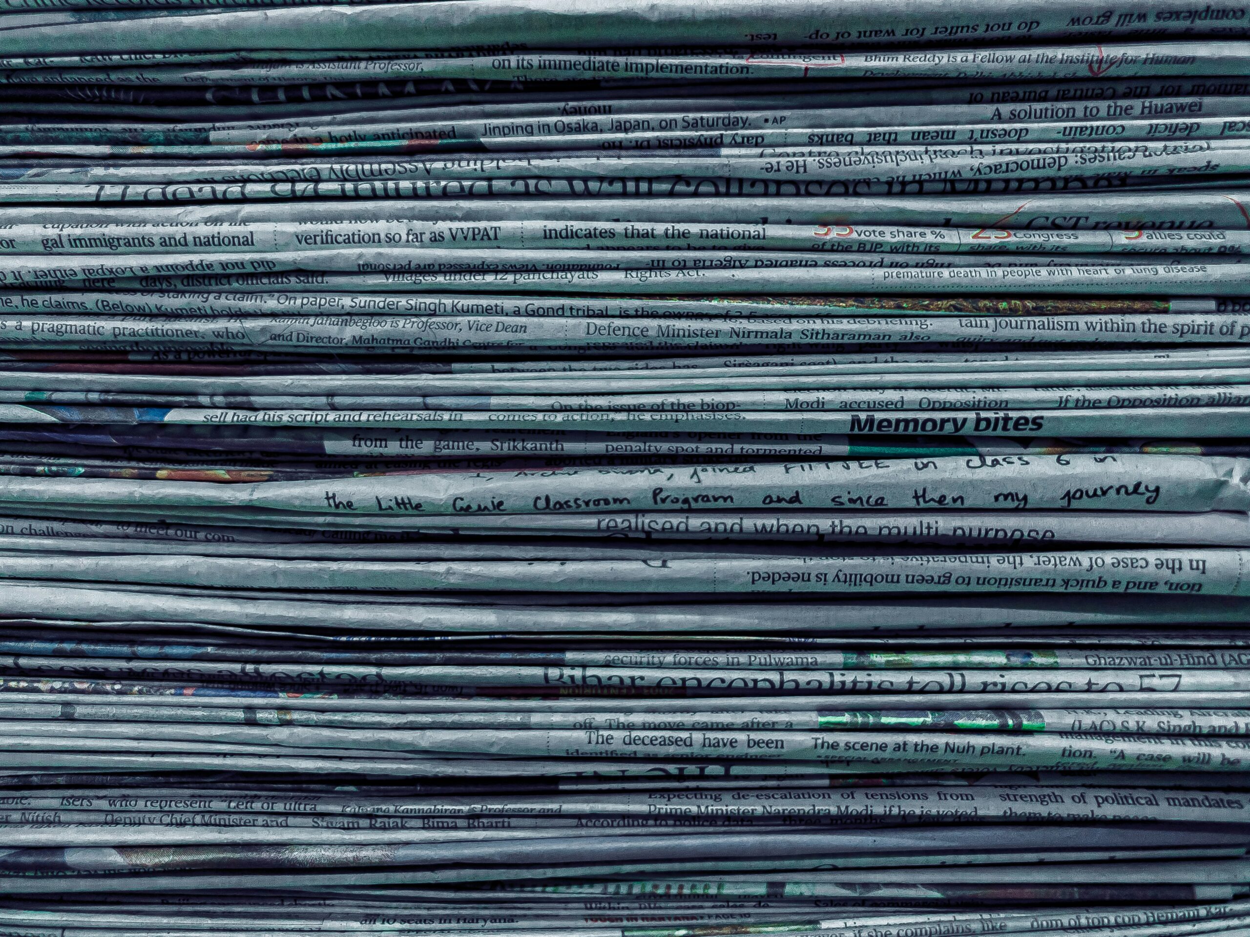 A close up of a large stack of newspapers.