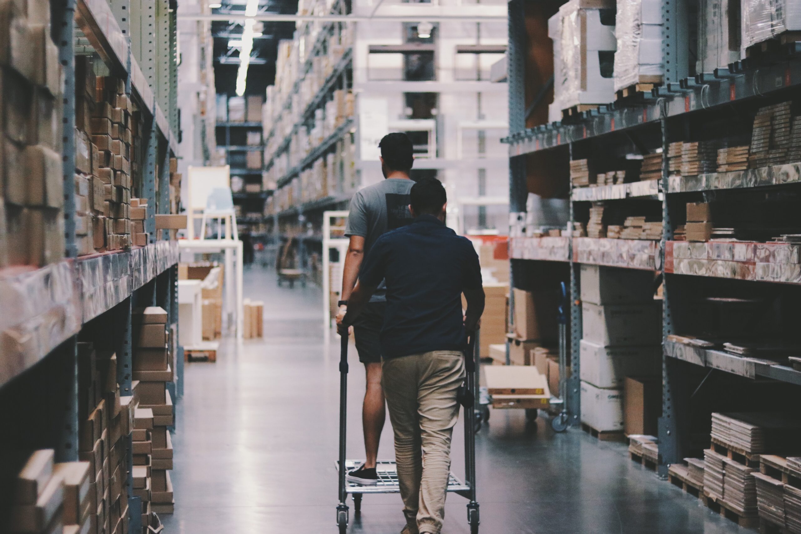 Two employees in an Amazon fulfillment warehouse