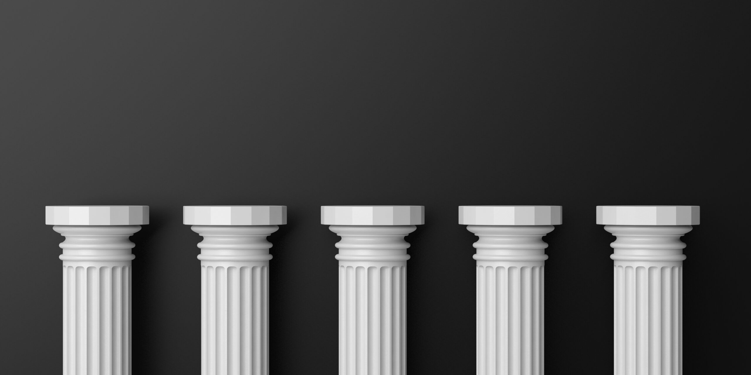 Five white pillars in front of a dark grey background.