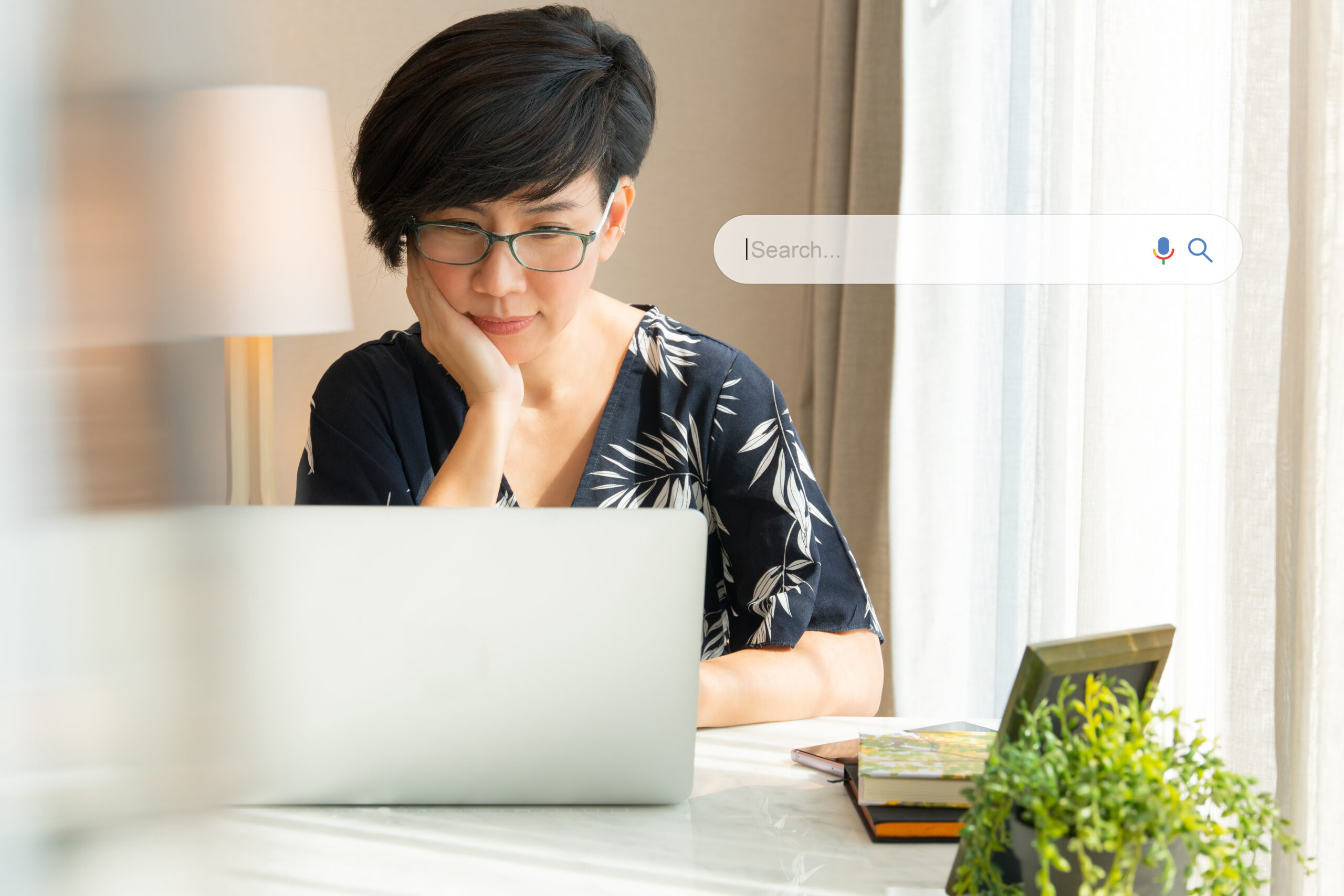 A person works on a laptop while seated at a desk.