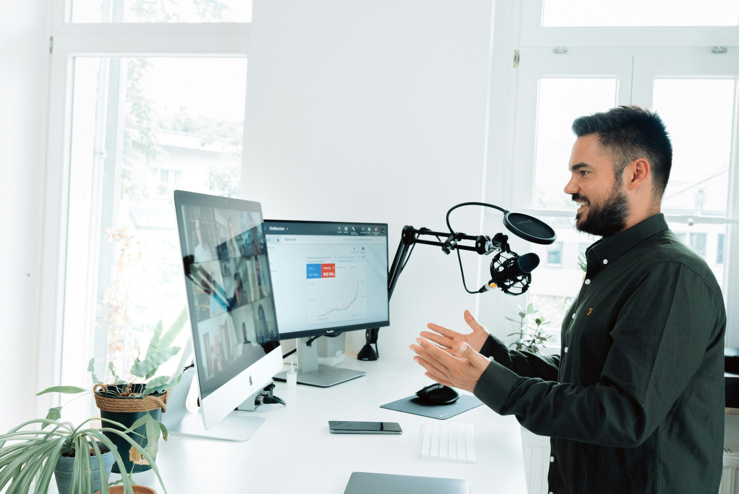 A person on a video call looks at their computer monitors.