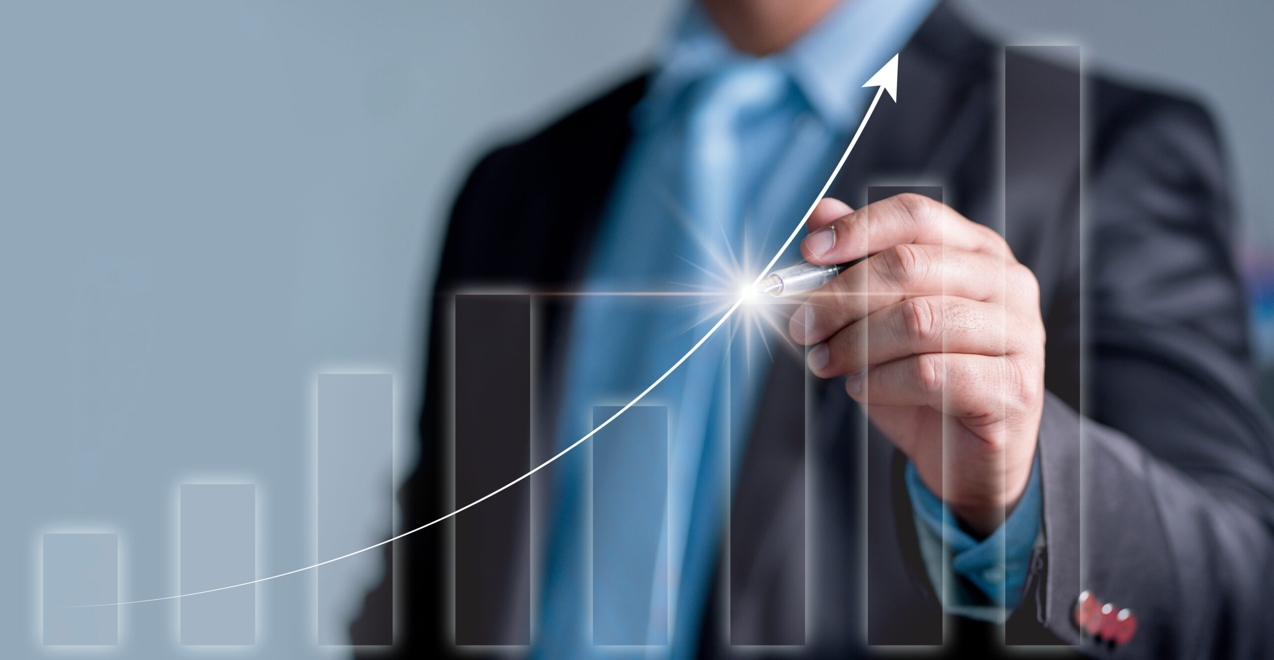 A professional uses a pen to draw an imaginary like matching the trajectory of a superimposed bar graph.