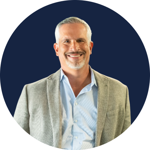 Tom Augustine in dark blue circle